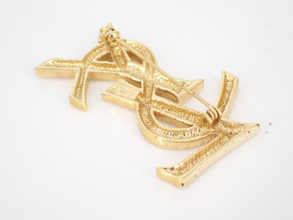 yves saint laurent gone-tone logo brooch
